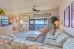 Relax after a long day in this comfortable living room with ocean views